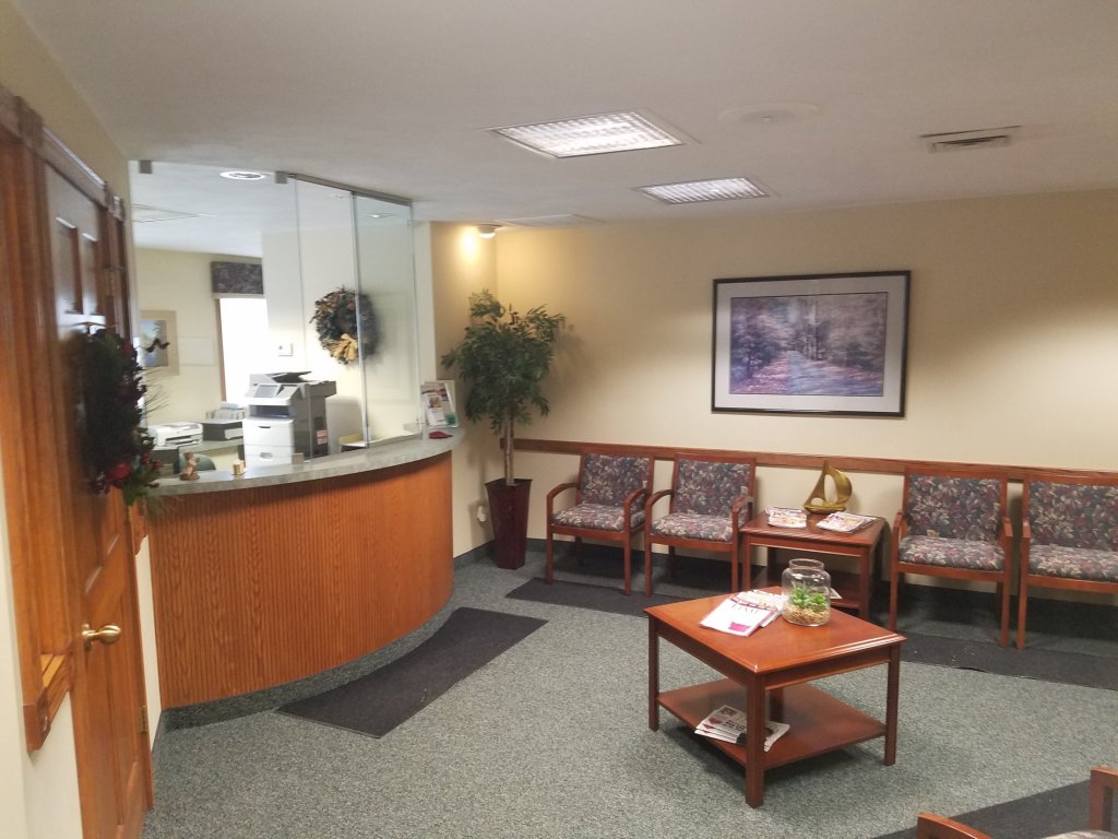 Reception Area with front desk and chairs at [LAST_NAME]'s practice